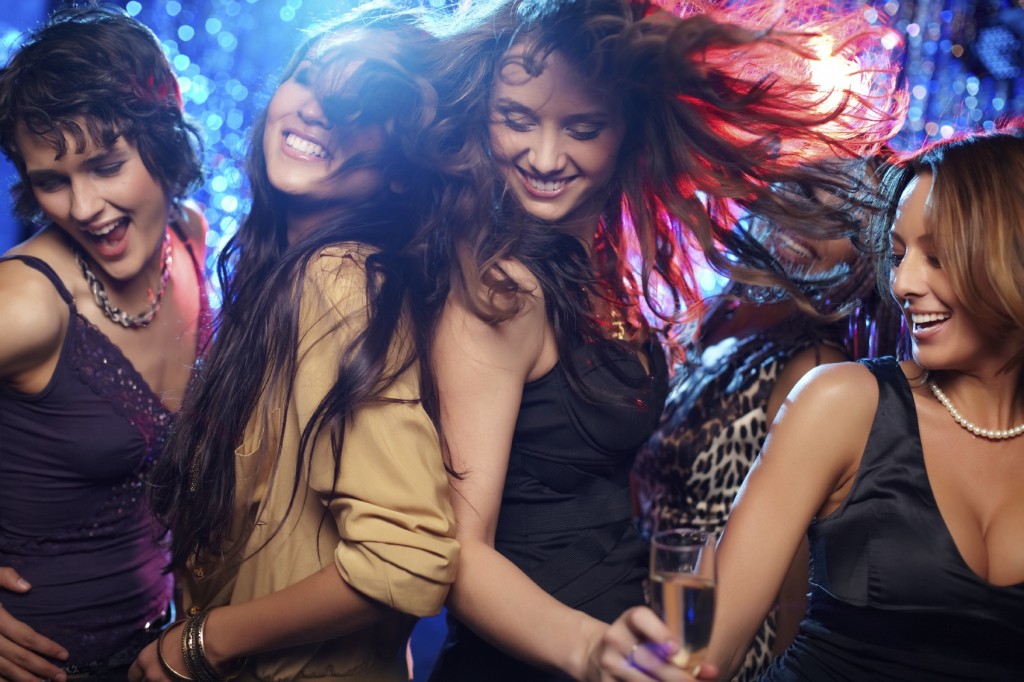 Young women having fun dancing at nightclub